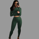 Person taking a mirror selfie wearing a green outfit 