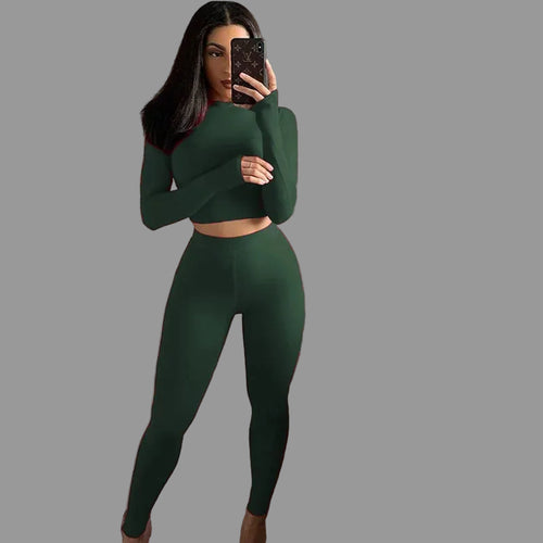 Person taking a mirror selfie wearing a green outfit 
