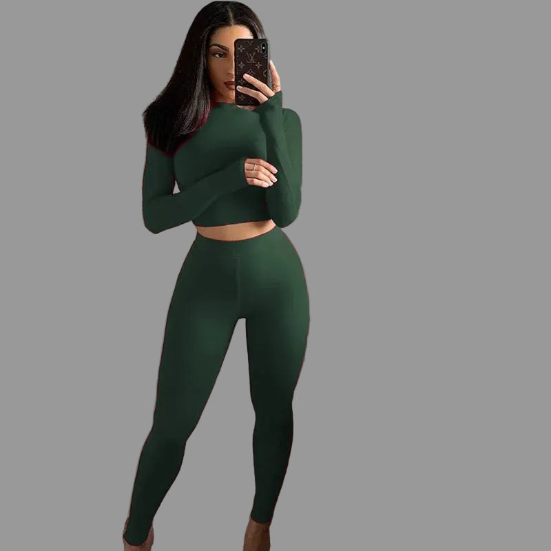 Person taking a mirror selfie wearing a green outfit 