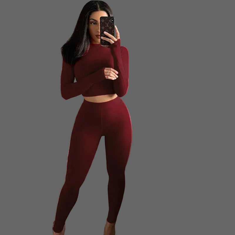 Person taking a mirror selfie wearing a burgundy outfit 