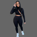 Woman in black long-sleeve top and leggings 