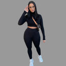 Woman in black long-sleeve top and leggings 