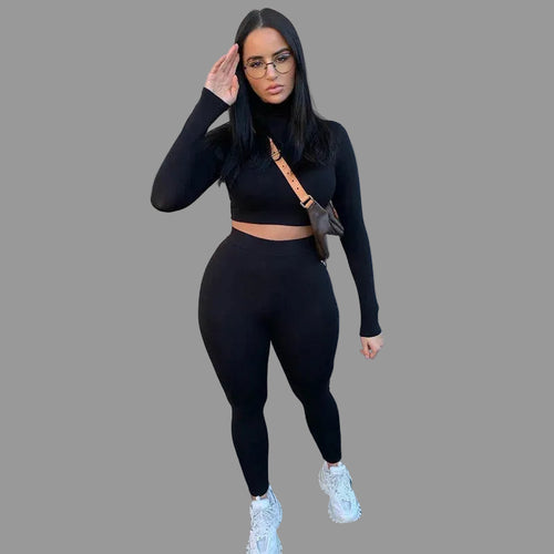 Woman in black long-sleeve top and leggings 