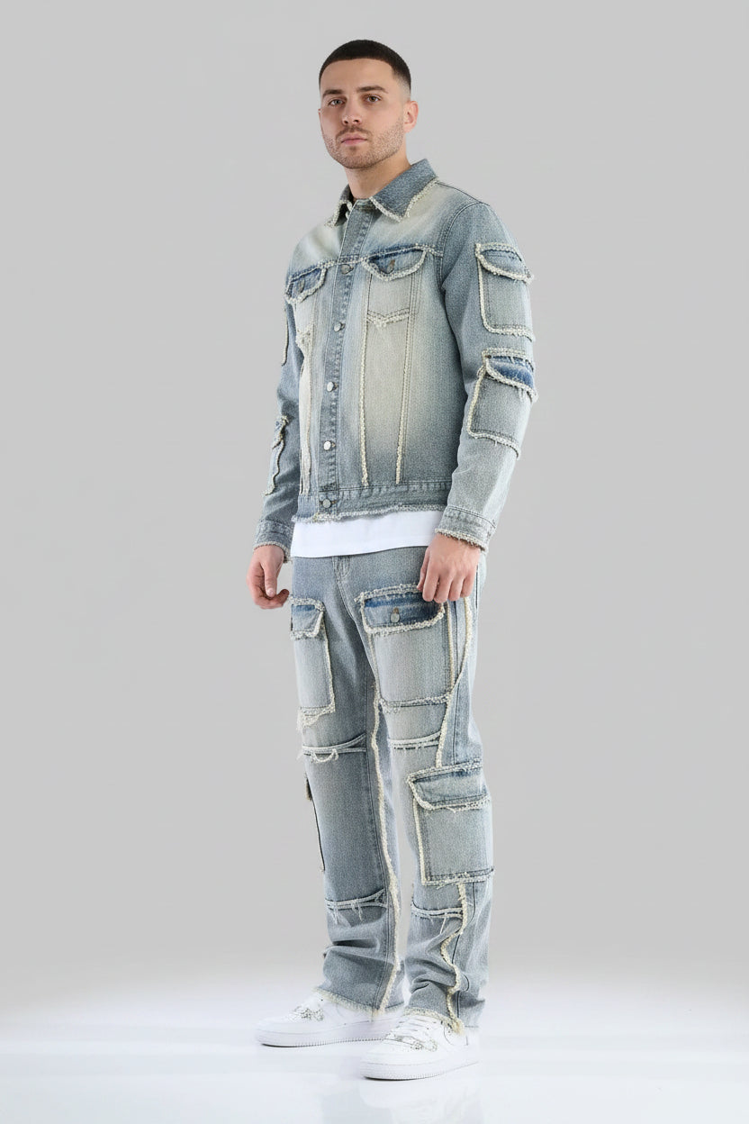 Person wearing a distressed denim jacket and jeans on a gray background