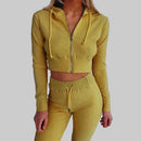 Yellow ribbed tracksuit worn by a person on a white background