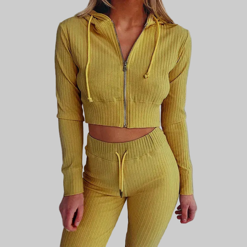 Yellow ribbed tracksuit worn by a person on a white background