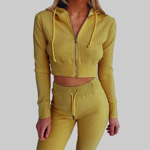 Yellow ribbed tracksuit worn by a person on a white background