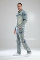 Person wearing a patchwork denim outfit on a gray background
