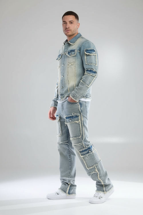 Person wearing a patchwork denim outfit on a gray background