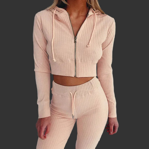 Beige ribbed knit hoodie and pants set on a plain background