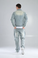 Person wearing a light blue denim jacket and pants on a white background