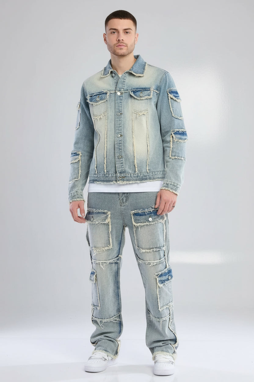 Person wearing a patchwork denim jacket and jeans on a gray background