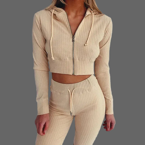 Beige ribbed knit hoodie and pants set on a plain background