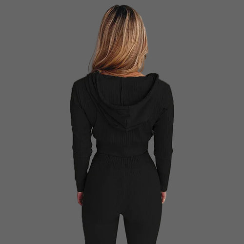 Person wearing a black hooded outfit against a white background
