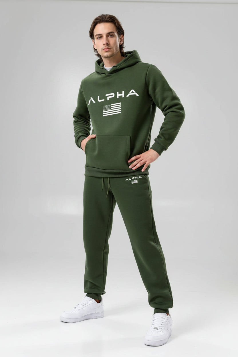 Person wearing a green Alpha tracksuit on a white background