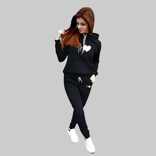 Woman wearing a black tracksuit with a gray background