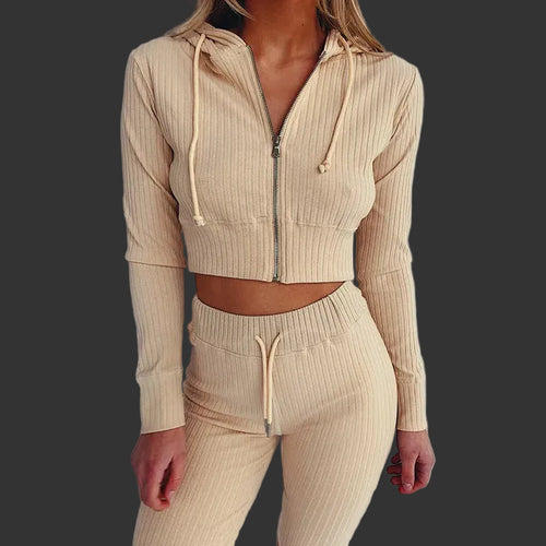 Beige ribbed knit hoodie and pants set on a plain background