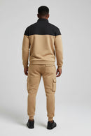 Two-tone tracksuit with black and beige design on a white background