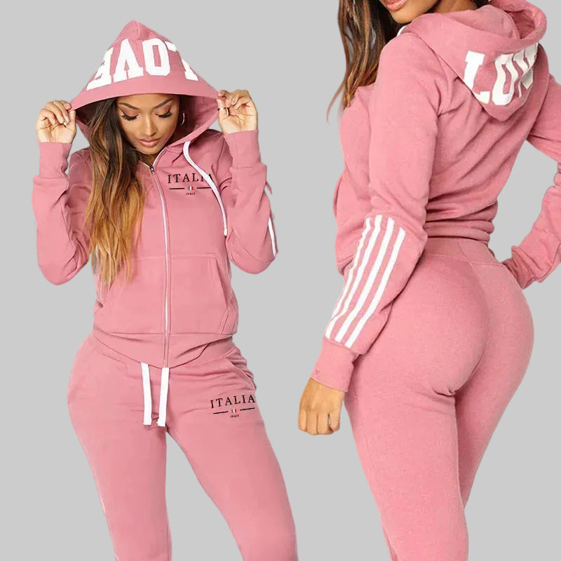 Pink tracksuit with 'ITALIA' branding worn by a model on a white background