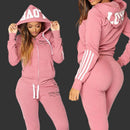 Pink tracksuit with 'ITALIA' branding worn by a model on a white background
