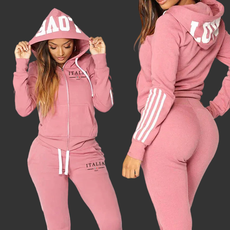 Pink tracksuit with 'ITALIA' branding worn by a model on a white background