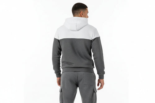 Gray and white color-blocked hoodie and pants set on a white background
