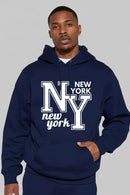 Person wearing a navy blue hoodie with 'New York NY' text on a gray background