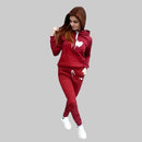 Woman wearing a red tracksuit with a heart design on a gray background