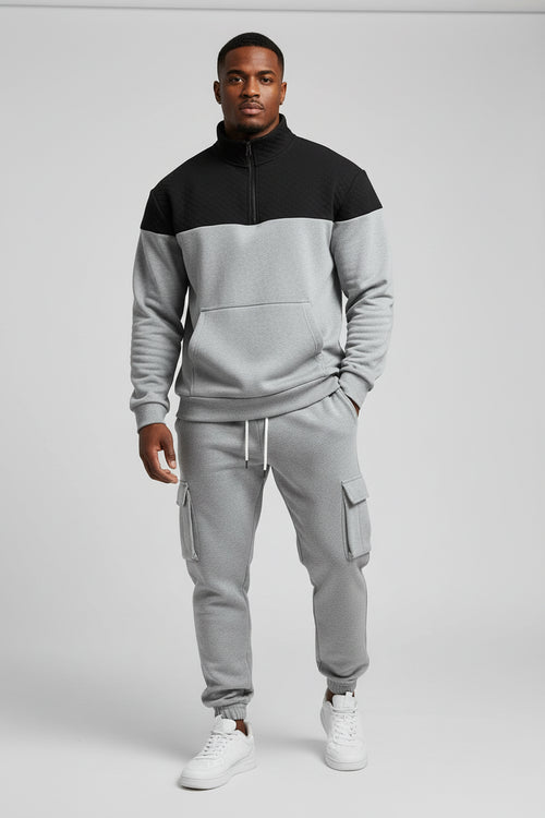 Two-tone hoodie and jogger pants set on a white background