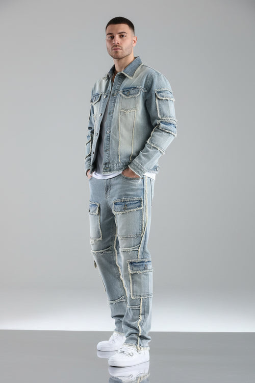 Person wearing a patchwork denim outfit on a gray background