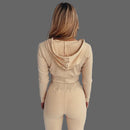 Person wearing a beige ribbed knit outfit against a white background