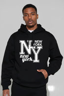 Person wearing a black hoodie with 'New York NY' text on a gray background