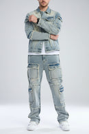 Person wearing a light blue denim jacket and pants on a gray background