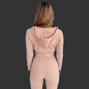 Person wearing a pink ribbed knit outfit against a white background