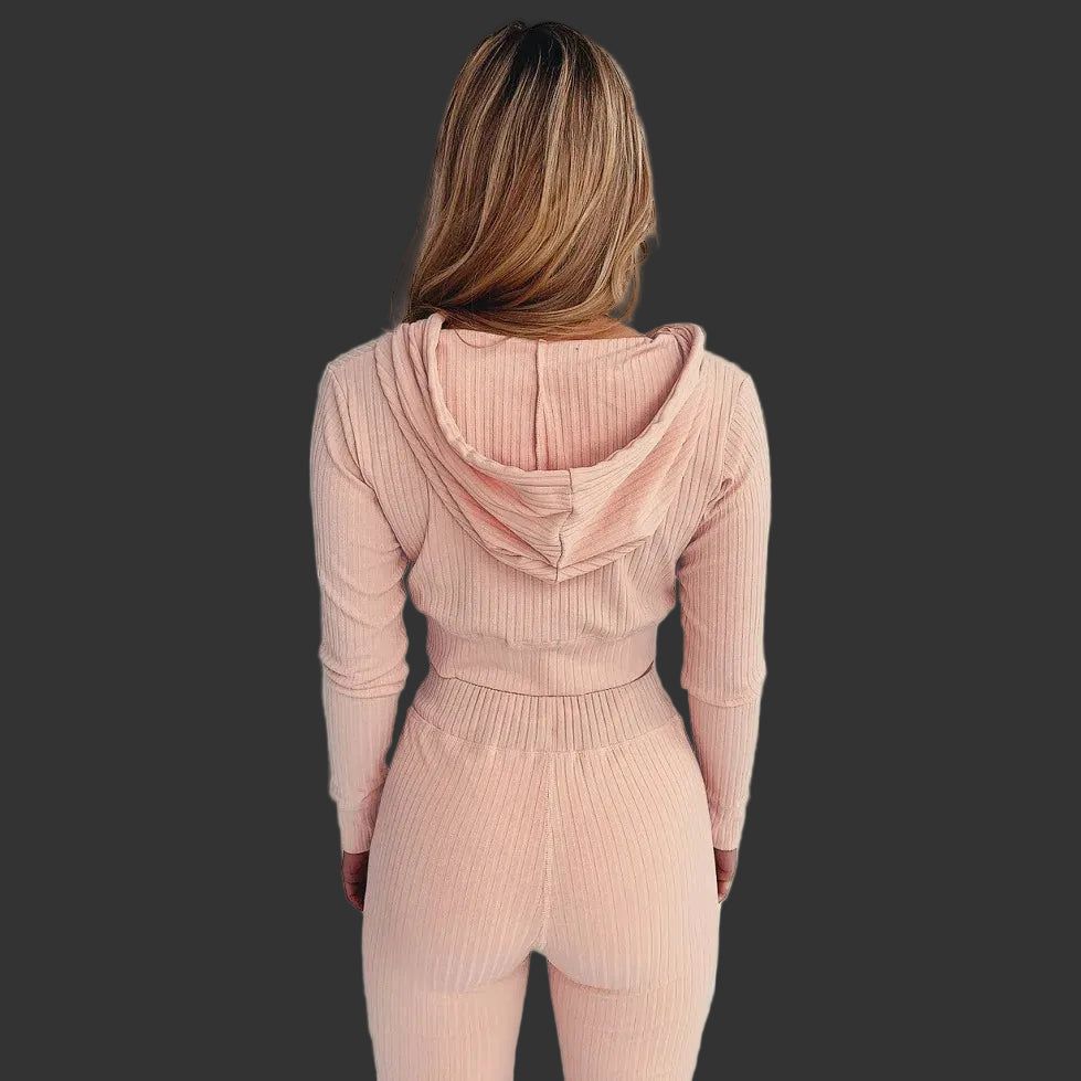 Person wearing a pink ribbed knit outfit against a white background
