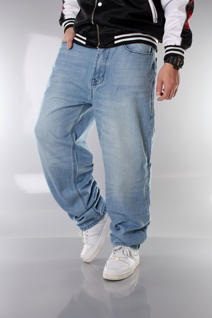 Person wearing light blue baggy jeans on a white background