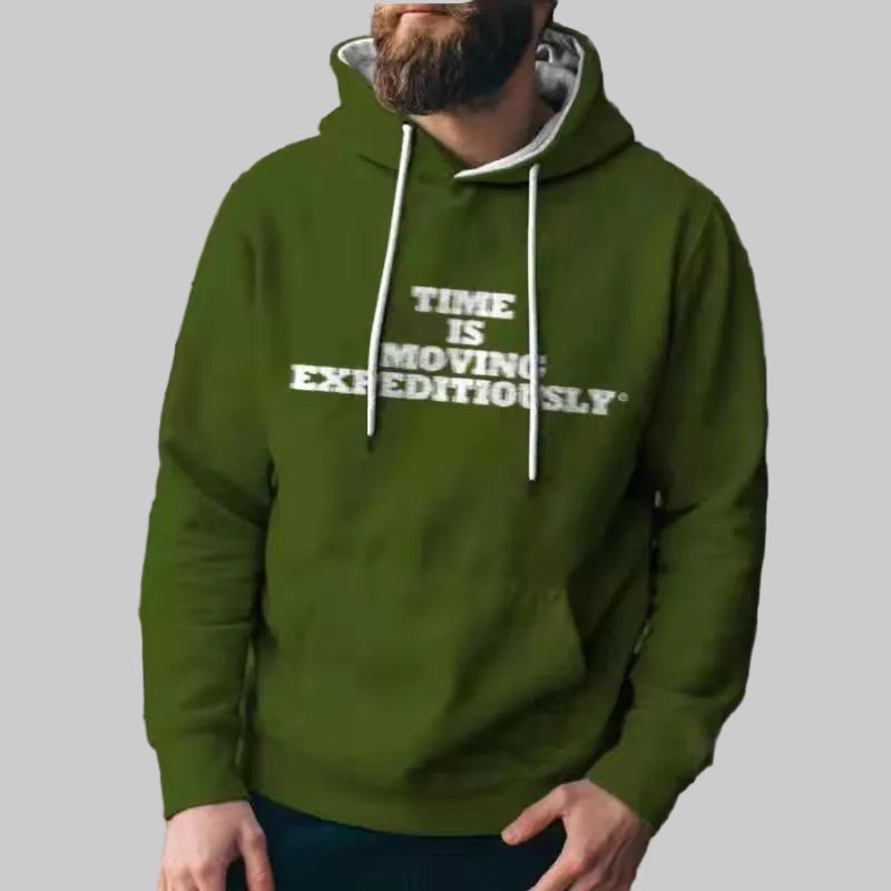 Person wearing a green hoodie with text against a wire fence background